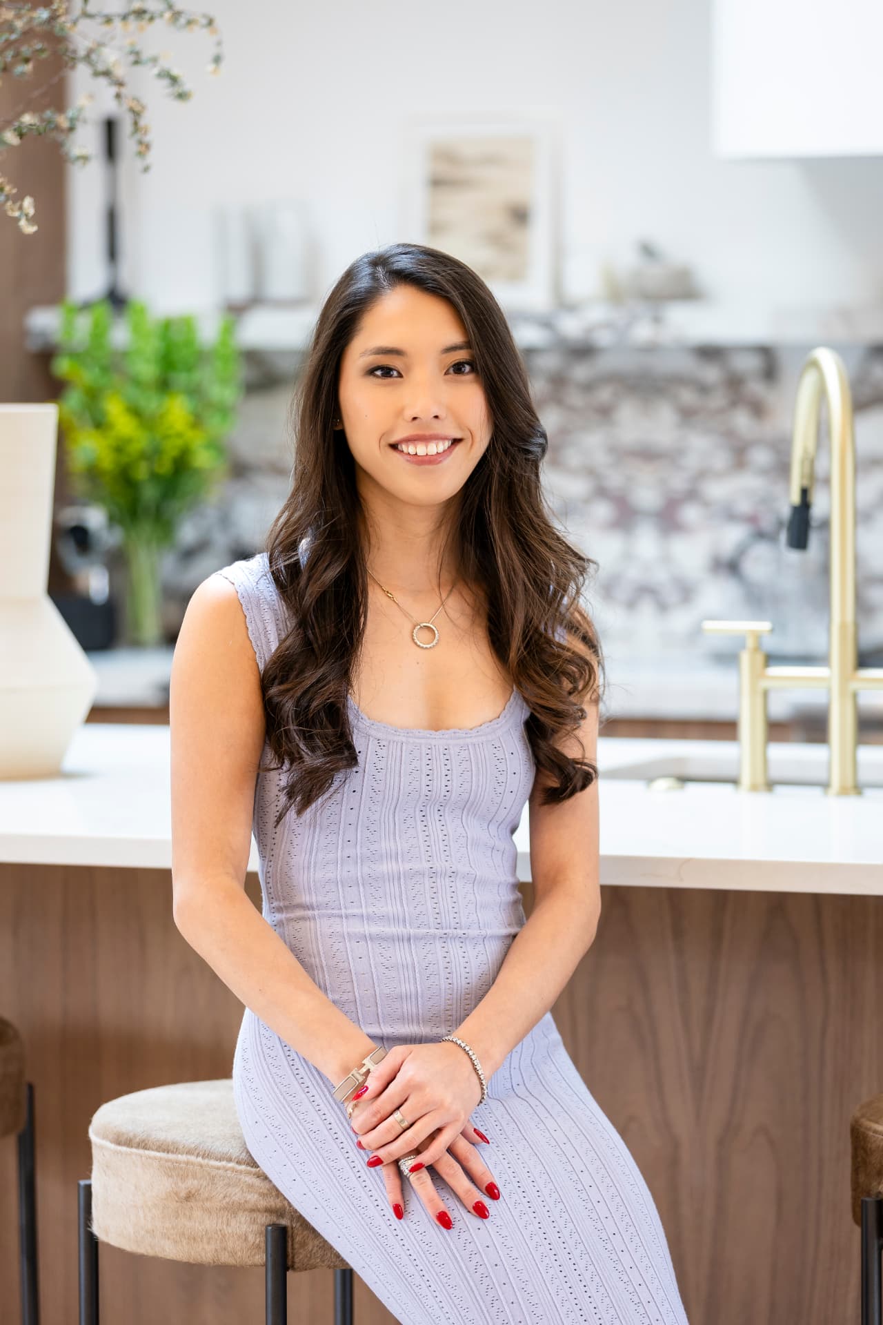 Alyssa Nguyen seated at a marble kitchen island